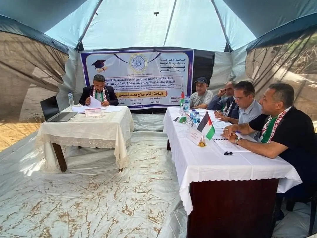 Students and faculty in discussion at a shared table